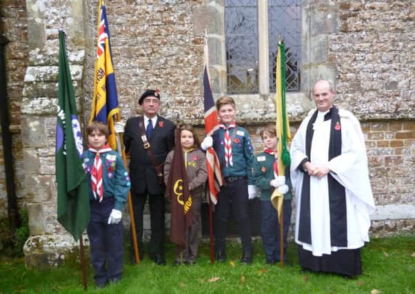 Rev Michael Brydon with representatives from Crowhurst Cubs, Scouts, Brownies and the Royal British Legion
