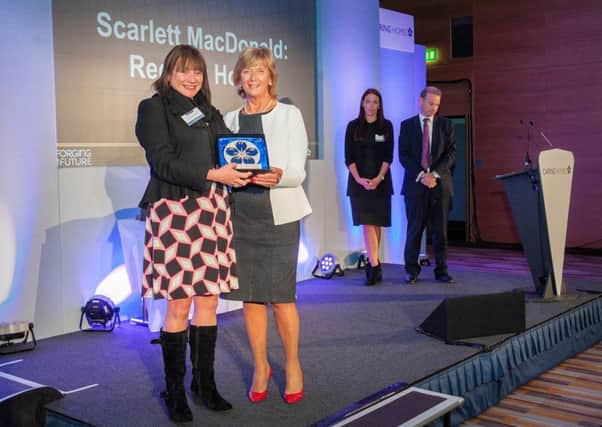 Scarlett MacDonald receives her Leader of the Year award from Caring Homes