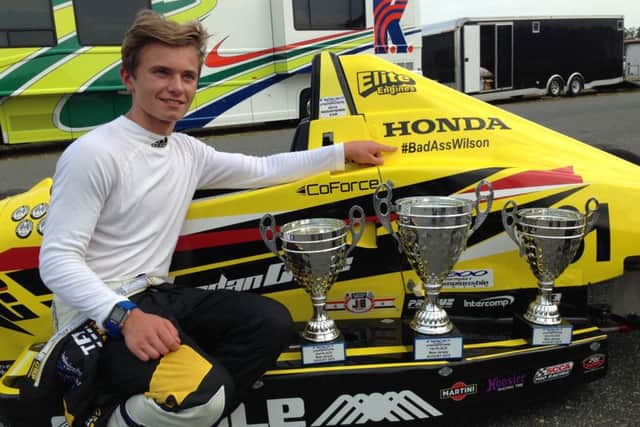 Jordan Cane with his F1600 car and some of his numerous race trophies