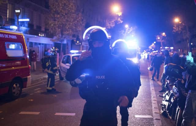 Elite police officers arrive outside the Bataclan theatre in Paris (AP) PPP-151114-110556001