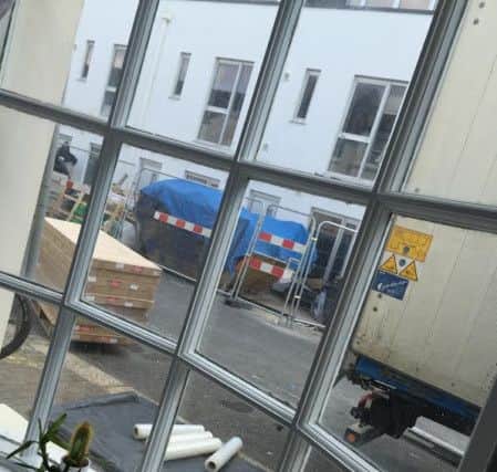 A photo taken by a resident from their lounge window showing a lorry unloading materials onto the pavement SUS-151117-171150001
