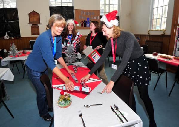 24/12/14- Surviving Christmas at the Salvation Army Hall in St Andrews Square, Hastings. Laying out tables for Christmas Day SUS-141224-121155001