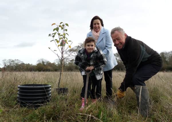 Cub Katie Clarke, eight, and mum Tracy Clarke, from Emsworth, plant a tree with 1st Westbourne Scout group leader Derek Chaffer