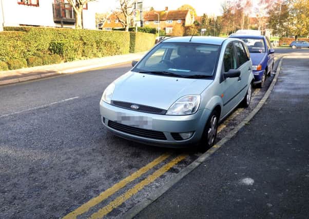 Cars parked on double yellow lines in Battle. SUS-151123-115622001