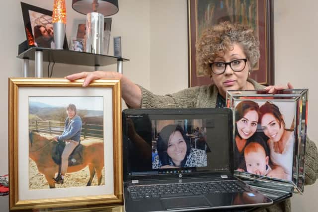 Bev Fletcher pictured with photographs of her daughter Kim and of family.