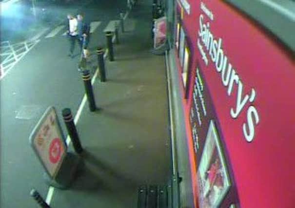 A CCTV image of the two men and the dog outside Sainsbury's in Rustington PICTURE FROM SUSSEX POLICE