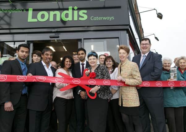 Cutting the ribbon for Londis Caterways opening.