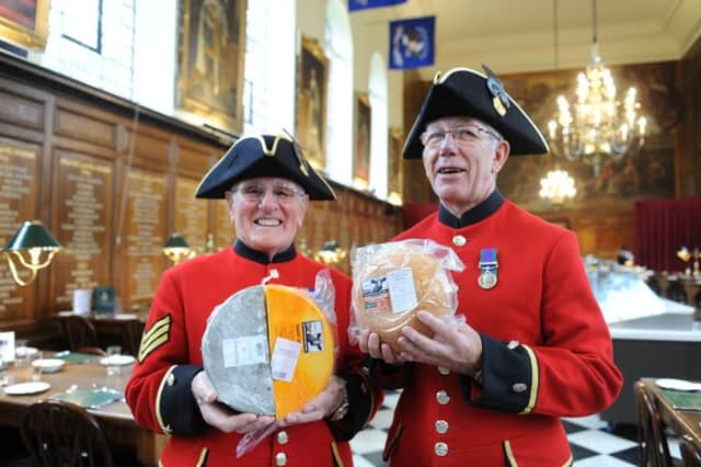 Chelsea pensioners with some of the Sussex High Weald cheese presented to them in an ancient ceremony SUS-150412-170232001