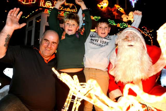 Wayne Thair with his sons and Father Christmas on Saturday