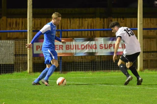 Bexhill United substiute Aaron Tudor keeps a close eye on Callum Saunders. Picture courtesy Grahame Lehkyj