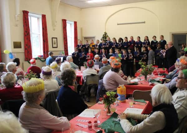 The Junior School of Windlesham House School entertain guests at the
Storrington Christmas Pop-In Lunch. SUS-150912-111111001