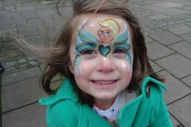 Laila Suki has her face painted at the Stagecoach stall