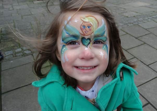 Laila Suki has her face painted at the Stagecoach stall