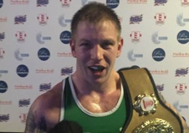 Shaun Attrell, of West Hill Boxing Club, clutches his championship belt