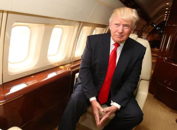 File photo dated 15/5/2014 of American tycoon Donald Trump onboard his private jet. More than 360,000 people have backed a call for Donald Trump to be banned from the UK after he suggested Muslims should be barred from America. PRESS ASSOCIATION Photo. Issue date: Thursday December 10, 2015. Thousands rushed to sign a petition on the Parliament website as British politicians lined up to condemn the remarks. The property tycoon and reality TV star, who is seeking the Republican nomination for next year's presidential election, provoked widespread anger and ridicule after demanding a block on Muslims entering the US and claiming parts of London were "so radicalised" that police were "afraid for their own lives". See PA story POLITICS Trump. Photo credit should read: Andrew Milligan/PA Wire POLITICS_Trump_084400.JPG