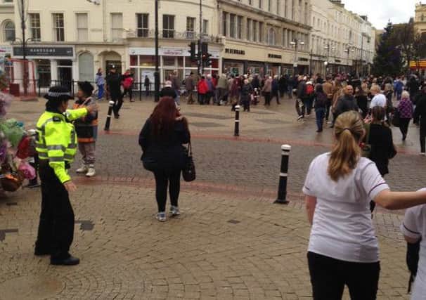 Shoppers being evacuated from the town centre by police due to a 'suspicious package'. Photo by Richard Warner