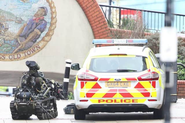 The EOD took the incident very seriously as a package was also found by a police car. Photo by Eddie Mitchell