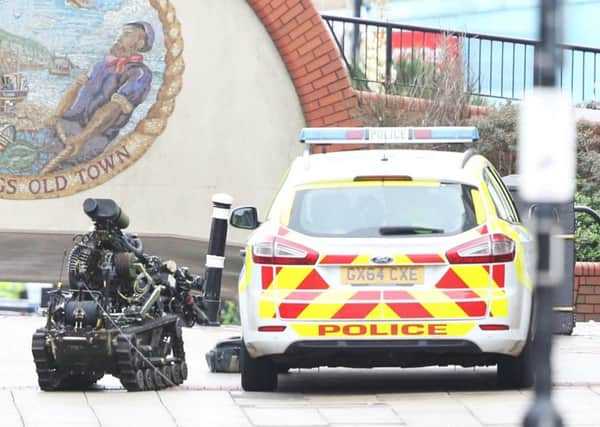 The EOD took the incident very seriously as a package was also found by a police car. Photo by Eddie Mitchell
