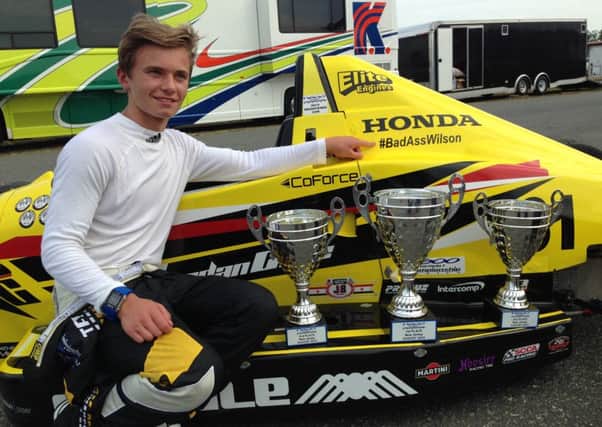 Jordan Cane with his F1600 car and some of his trophies