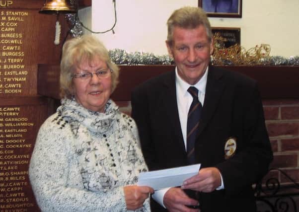 Selsey cets' captain David Winter hands a cheque to Jill Sturdey