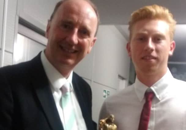 Louis Paul receives his award from the BBC's Jonathan 'Aggers' Agnew