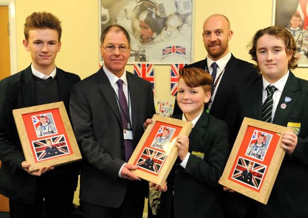 Students at Chichester High School for Boys watched the live launch of astronaut Tim Peake going to space. Three boys from the Junior Leadership Team that applied to work with the BBC on a project received momentos. Picture Steve Robards  SR1528387