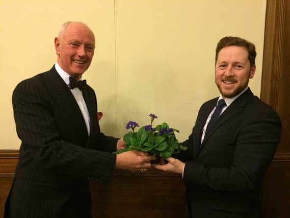 UKIP leader Charles James, left was presented with the 'UKIP-themed' flowers last night