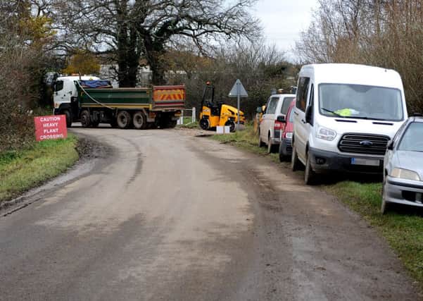Pic of muddy road and parked builders' vehicles causing chaos during building of nearby Priors Byne solar farm - local residents are angry over the mess. Pic Steve Robards SR1526775 SUS-150212-165113001