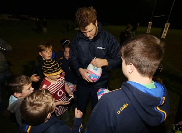 Joe Launchbury signs autographs at the coaching session