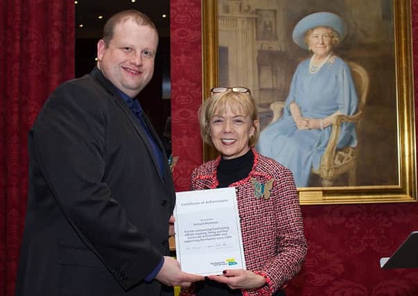 Richard Matthews receives his award from Sue Owen, chairman of the Charity for Civil Servants