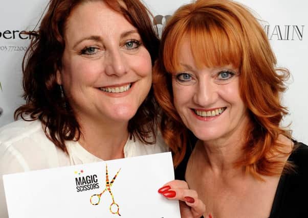 Hairdresser Carol Brown (left) cut Lin Harrison's hair and donated the money as part of a nationwide campaign 'Magic Scissors' launched by her friend. Pic Steve Robards SR1528733 SUS-151221-120250001