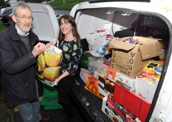 Simon Earl, Project Manager Bexhill Foodbank, picking up food donations from the Hastings Observer offices. Simon is pictured with reporter Laura Cooke. SUS-151222-102449001