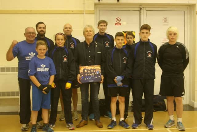 St Gerards members and coaches make a presentation to Phil Haddow, whose Haddow Electrical is a big supporter oftheir annual black-tie show