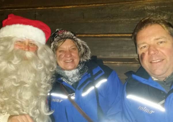 Nikki Hopkins, husband Mark and Santa in Lapland SUS-151222-175623001