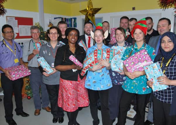 Staff from Kipling Ward and representatives from Secure Care UK with the donated presents