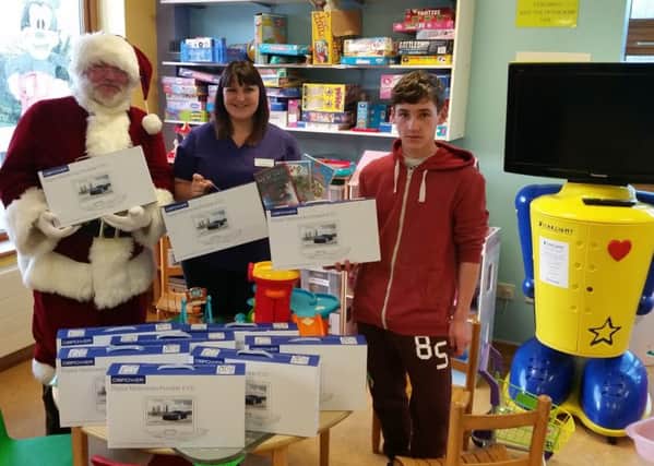 Westley helps Santa deliver the gifts to the children's ward at Worthing Hospital