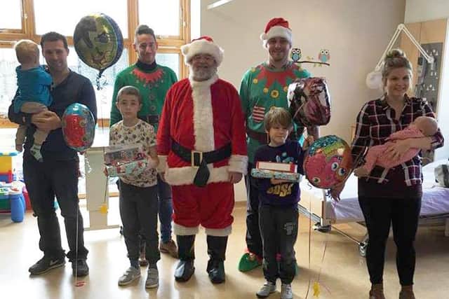 Santa and his elves greet some of the families on Bluefin Ward at Worthing Hospital