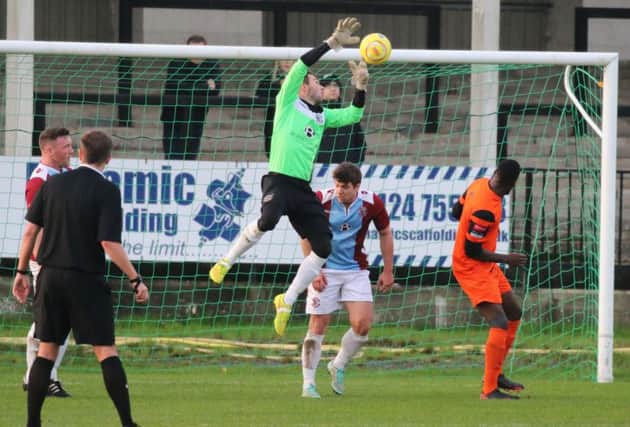 Hastings United goalkeeper Matt Cruttwell tries to gather the ball during the 1-0 win at home to Walton Casuals on Boxing Day. Picture courtesy Joe Knight