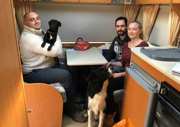 Jan and Jessica Kuppers, with their two dogs, in the caravan having been taken in by Mark (left) and his family