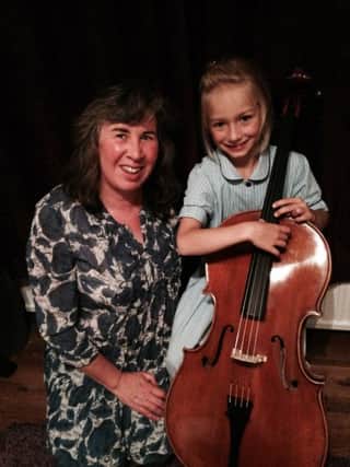 Young cellist Suzannah Clark, aged eight, who has been given a place in the National Children's Orchestra. Pictures with her teacher Kay Tucker of Stringbabies - picture submitted