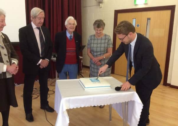 Florian Schweizer cuts the cake at the Steyning DFAS 10th anniversary celebrations SUS-160601-105515001