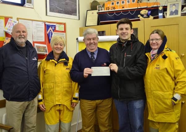 Richard Tandy, Stagecoach local operations manager, presenting a cheque to Eastbourne Lifeboats operations manager, Paul Metcalfe, with (from left) are Paul Huntley Deputy launch Authority,  Jill Wakefield shore-helper and Sue Holt shore-helper. SUS-160113-112325001