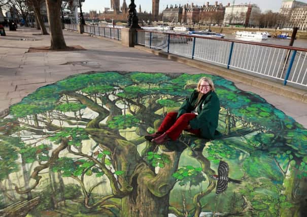 EDITORIAL USE ONLY
Beccy Speight, CEO The Woodland Trust, interacts with an 8x6m 3D artwork created by The Woodland Trust on Londons South Bank to announce a call for a new UK Charter for Trees, Woods and People, which will be led by the Woodland Trust andÂ supported by 47 other organisations. PRESS ASSOCIATION Photo. Picture date: Wednesday January 13, 2016. The charter will launch in November 2017, 800 years since Henry III signed the original Charter of the Forests. Photo credit should read: Matt Alexander/PA Wire