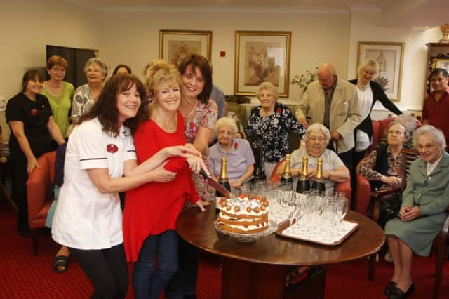 DM15223914a.jpg Shelley Care Home, Worthing, rated outstanding by the CQC. Beverley Papworth cuts the cake helped by Julie Shepard left and Nada Wakeford. Photo by Derek Martin