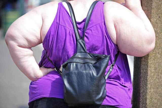 File photo dated 15/07/2008 of an overweight woman as being overweight contributes more to the most common form of breast cancer than alcohol or smoking, a study suggests.