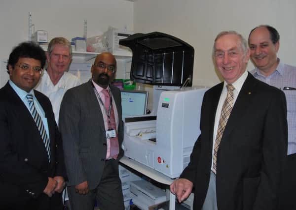Consultant Breast Surgeons and Peter Nash from the Eastbourne Hospital Friends (second right) with OSNA machine SUS-160113-113725001
