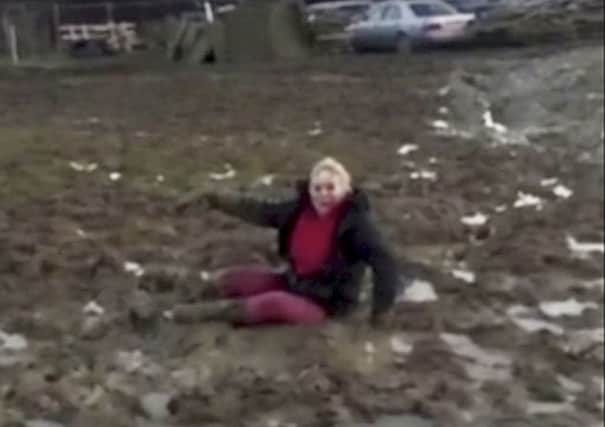 Sara Coull, 48, from East Sussex when she was stuck in the mud and filmed falling over. Photo from SWNS. SUS-160113-150359001