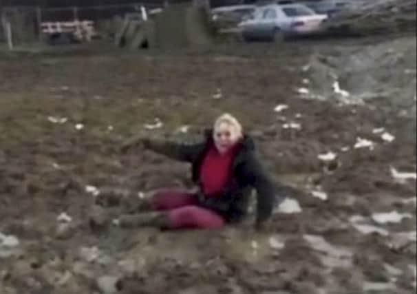 Sara Coull, 48, from East Sussex when she was stuck in the mud and filmed falling over. Photo from SWNS. SUS-160113-150359001