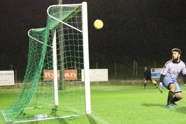 The East Grinstead Town goalkeeper is helpless as Sam Adams scores Hastings United's fourth goal with a tremendous strike from outside the box. Picture courtesy Scott White