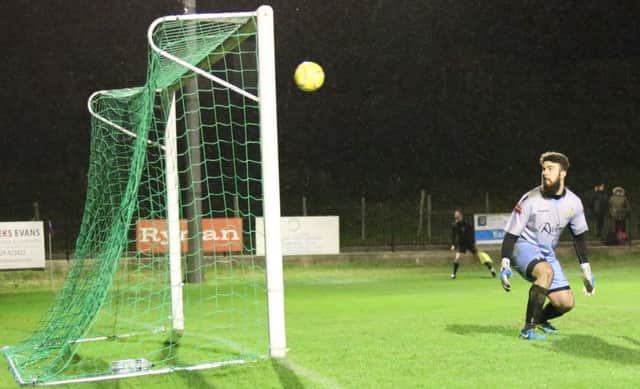 The East Grinstead Town goalkeeper is helpless as Sam Adams scores Hastings United's fourth goal with a tremendous strike from outside the box. Picture courtesy Scott White